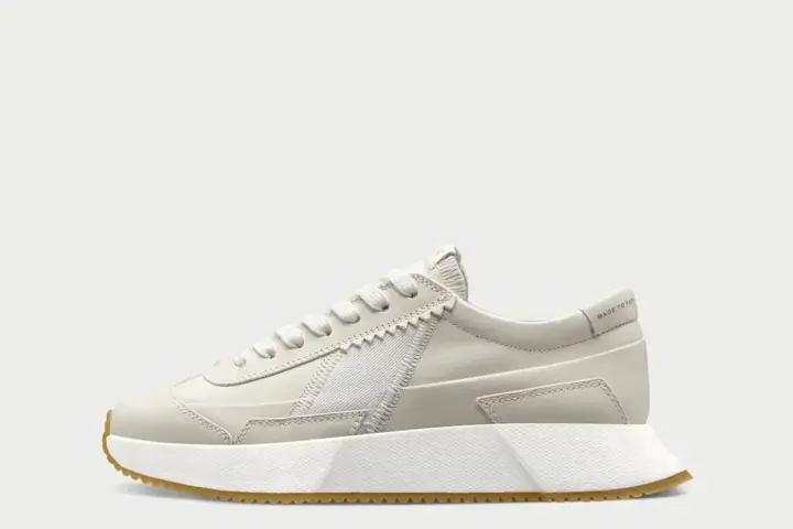 A compostable sneaker showcasing regenerative fashion design at a product awards event.