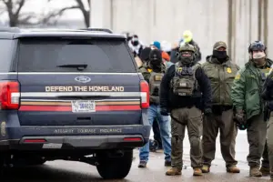An SUV marked 'Defend The Homeland' parked on a street.