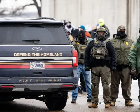 An SUV marked 'Defend The Homeland' parked on a street.