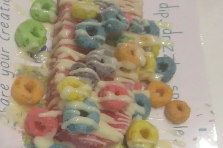 A frozen fruit bar on a stick with colorful toppings, representing the kind of frozen treat covered by the recall.