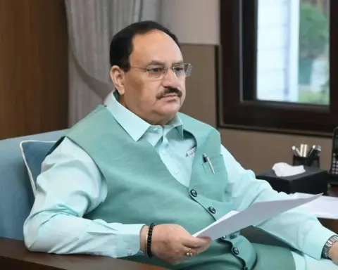 JP Nadda seated at desk reviewing documents during meeting