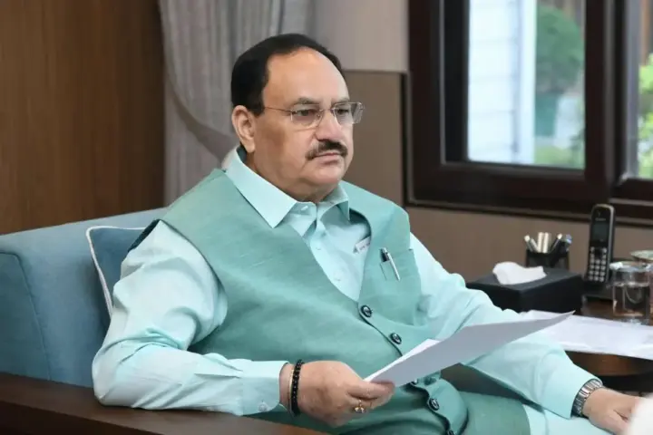 JP Nadda seated at desk reviewing documents during meeting