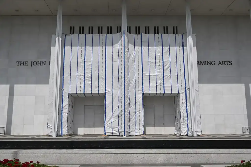 Exterior of the John F. Kennedy Center for the Performing Arts in Washington D.C., with scaffolding covering part of the facade.