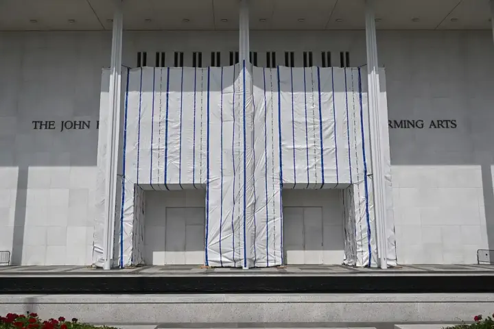 Exterior of the John F. Kennedy Center for the Performing Arts in Washington D.C., with scaffolding covering part of the facade.