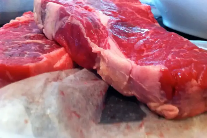 Raw beef cuts on a surface representing the recalled Argentine shipment