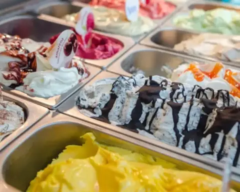 Various colored ice cream flavors in display case representing food safety testing of dairy and dairy-analogue products