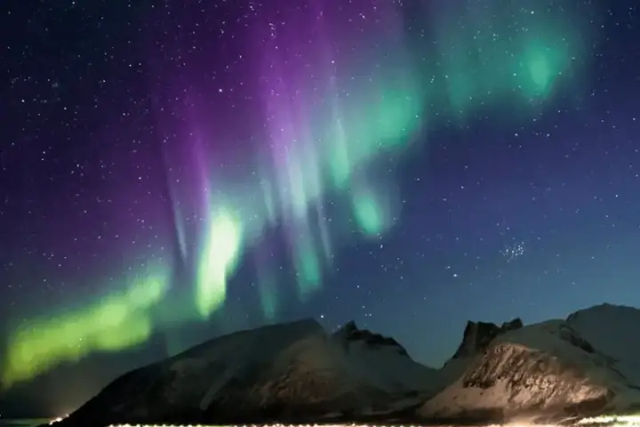 Vibrant green aurora borealis northern lights display across dark night sky during G2 geomagnetic storm event