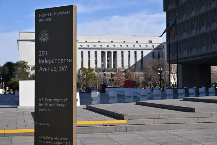 Freestanding dark sign in front of the Hubert H. Humphrey Building reading Hubert H. Humphrey Building, 200 Independence Avenue SW, U.S. Department of Health and Human Services, with the federal seal above