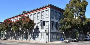 The Pioneer Building in San Francisco, the grey wood-clad corner office building housing OpenAI's headquarters