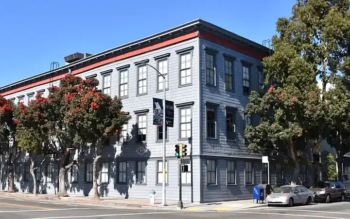 The Pioneer Building in San Francisco, the grey wood-clad corner office building housing OpenAI's headquarters