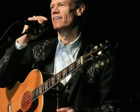 Country singer Randy Travis performing on stage.