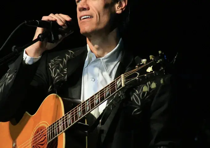 Country singer Randy Travis performing on stage.
