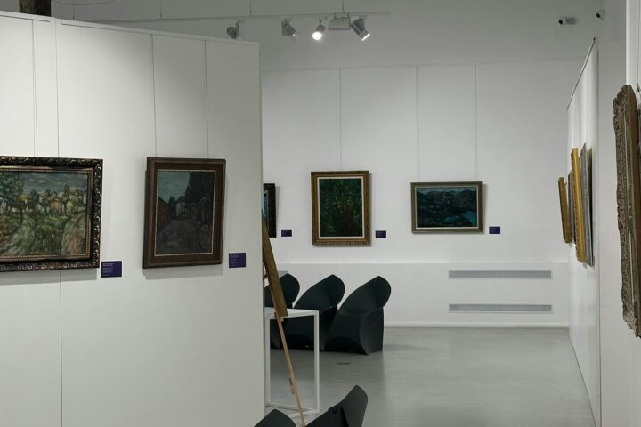 Art gallery interior with paintings displayed on white walls and visitors walking through — illustration of climate activism targeting cultural objects