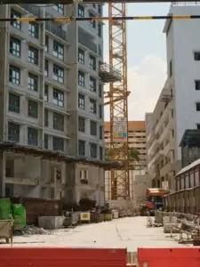 Urban construction site with tower crane and buildings under construction