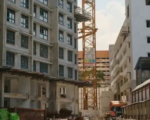 Urban construction site with tower crane and buildings under construction