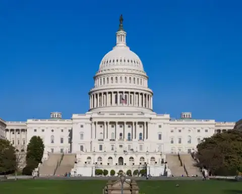 Exterior view of the United States Capitol building in Washington, D.C., showing the western front with its central dome and legislative wings.
