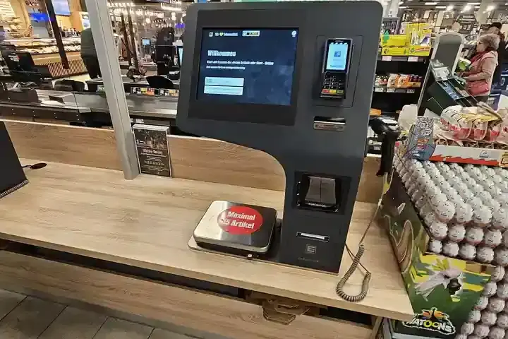 Self-checkout kiosk inside a supermarket aisle