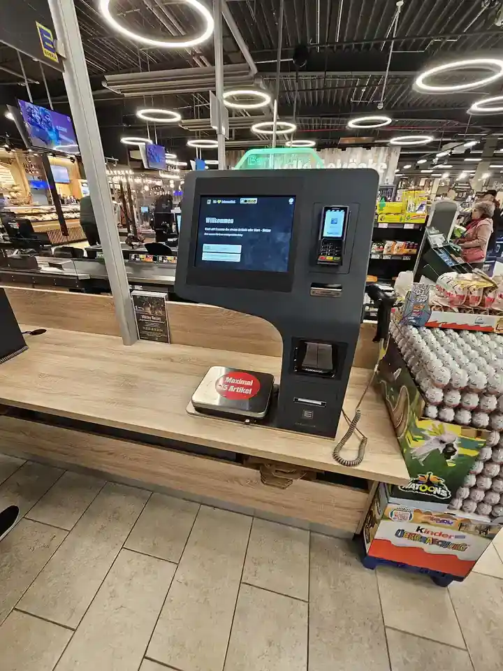 Self-checkout kiosk inside a supermarket aisle