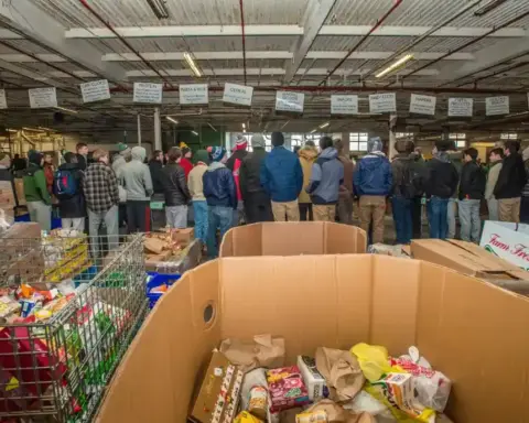 Volunteers sorting donated food at a community food bank.