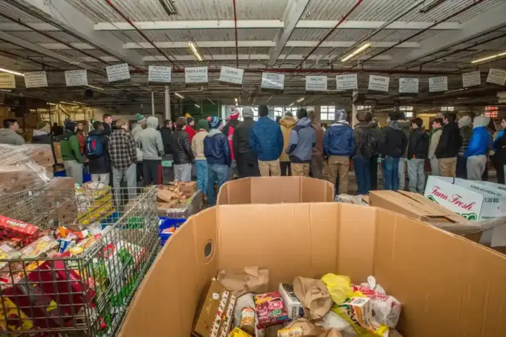Volunteers sorting donated food at a community food bank.