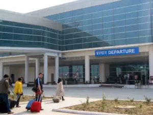 Interior of Varanasi airport departure hall with passengers and check-in counters