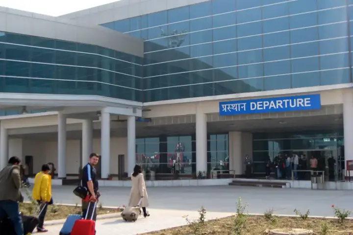 Interior of Varanasi airport departure hall with passengers and check-in counters