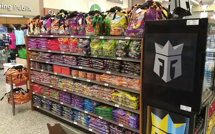 Retail store display featuring packaged Halloween candies and seasonal sweets on store shelves