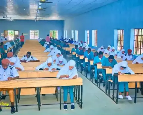 Students writing an examination in a hall