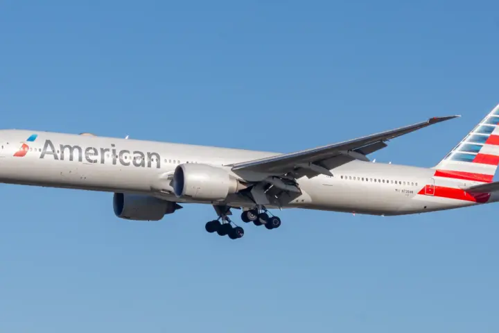 Side profile of an American Airlines Boeing 777-300ER widebody jetliner on an airport taxiway.