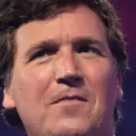 Tucker Carlson speaking to attendees at a public event in Arizona.
