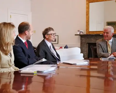 Portrait photograph of Bill Gates seated during a technology and global policy discussion.