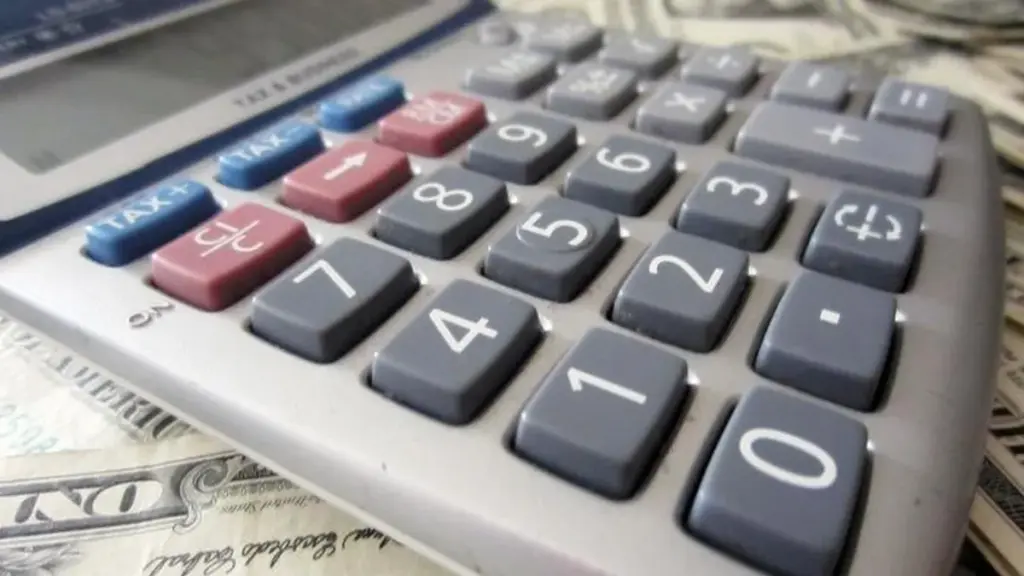 Money and a calculator used for a personal finance comparison.