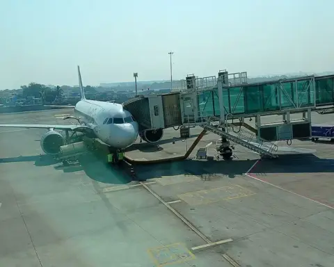 An IndiGo Airbus A321neo aircraft taxiing on the airport runway with engines and airline livery visible.