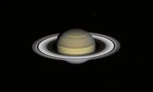 Full planetary disk of Saturn showing atmospheric bands and tilted ring system against the black background of space.