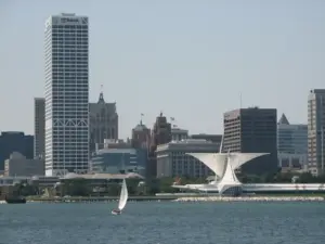 Distant view of the Milwaukee, Wisconsin skyline under hot summer daylight across the water.