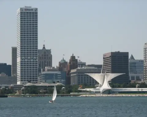 Distant view of the Milwaukee, Wisconsin skyline under hot summer daylight across the water.