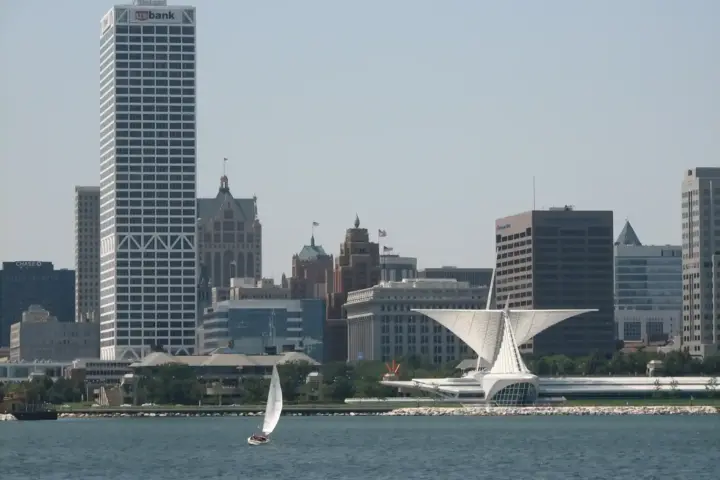 Distant view of the Milwaukee, Wisconsin skyline under hot summer daylight across the water.