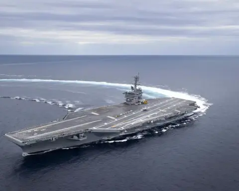 Aerial view of the Nimitz-class aircraft carrier USS Abraham Lincoln (CVN-72) navigating open ocean waters.