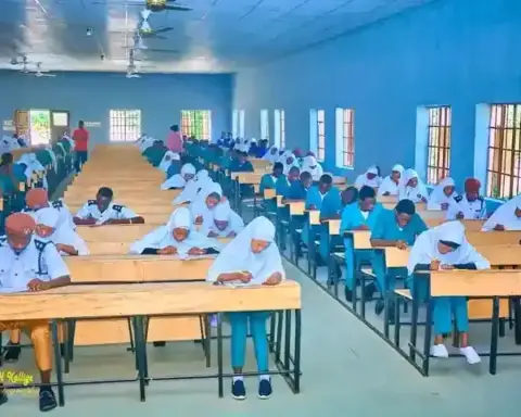 Students writing an examination in a hall, used to illustrate AIIMS NORCET admit-card checks