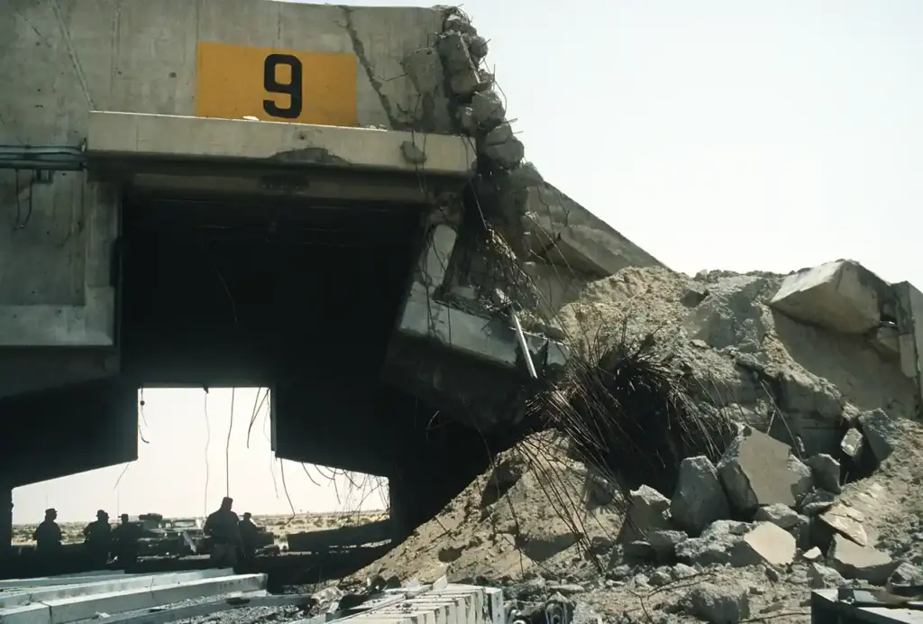 A hardened aircraft shelter at Ali Al Salem Air Base damaged during Operation Desert Storm, the kind of infrastructure loss behind the $37.5B war cost.