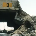 A hardened aircraft shelter at Ali Al Salem Air Base damaged during Operation Desert Storm, the kind of infrastructure loss behind the $37.5B war cost.