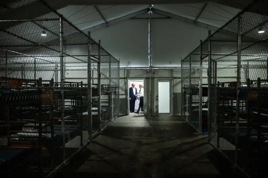 Interior view of the Alligator Alcatraz detention facility showing enclosed areas and rows of bunks.