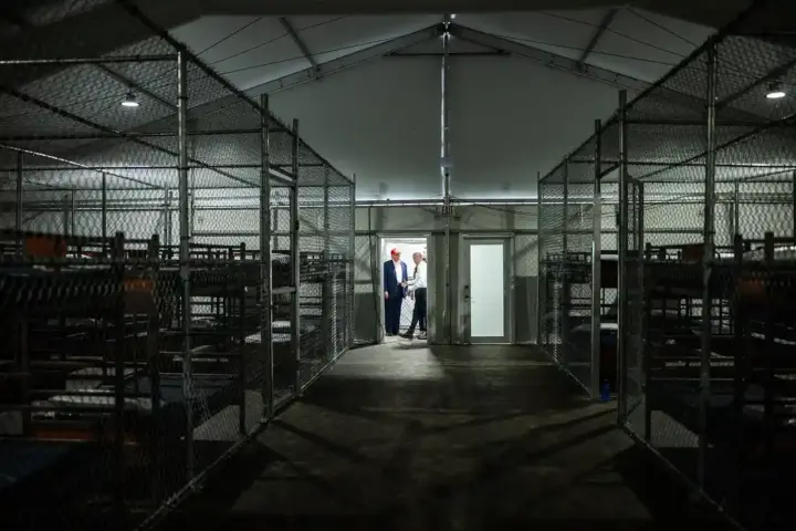 Interior view of the Alligator Alcatraz detention facility showing enclosed areas and rows of bunks.