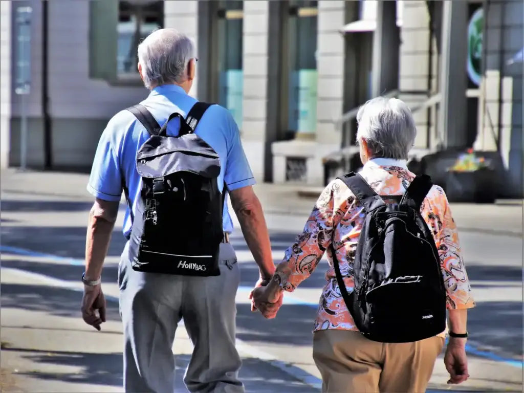 Close-up photograph of two individuals holding hands in compassionate family caregiving support