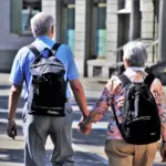 Close-up photograph of two individuals holding hands in compassionate family caregiving support