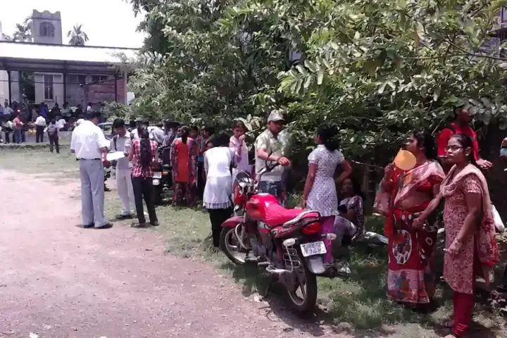 Students taking an examination in a hall, representing the APPSC Group 1 notification for 163 posts with age limit relief.