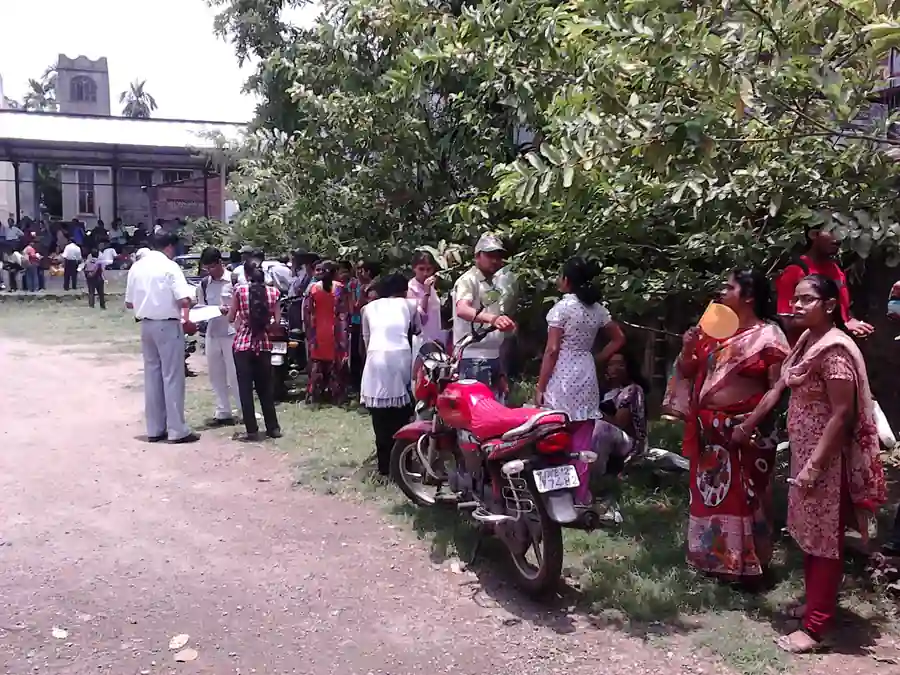 Students taking an examination in a hall, representing the APPSC Group 1 notification for 163 posts with age limit relief.