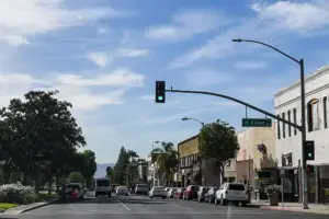 Street view of commercial buildings, paved roadways, and clear skies in downtown Ontario, San Bernardino County, California.