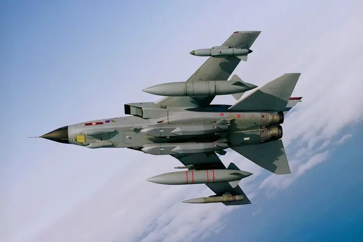 Underside view of a Royal Air Force aircraft in flight carrying two large, grey MBDA Storm Shadow air-launched cruise missiles.