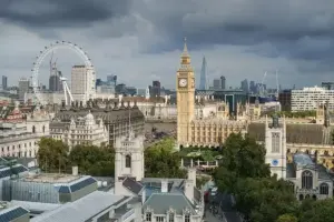 Elevated architectural view of the Palace of Westminster, Big Ben clock tower, and surrounding government offices in London.